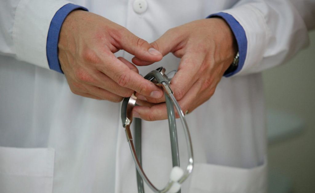 Close up of hands holding stethoscope: CC BY-NC 2.0