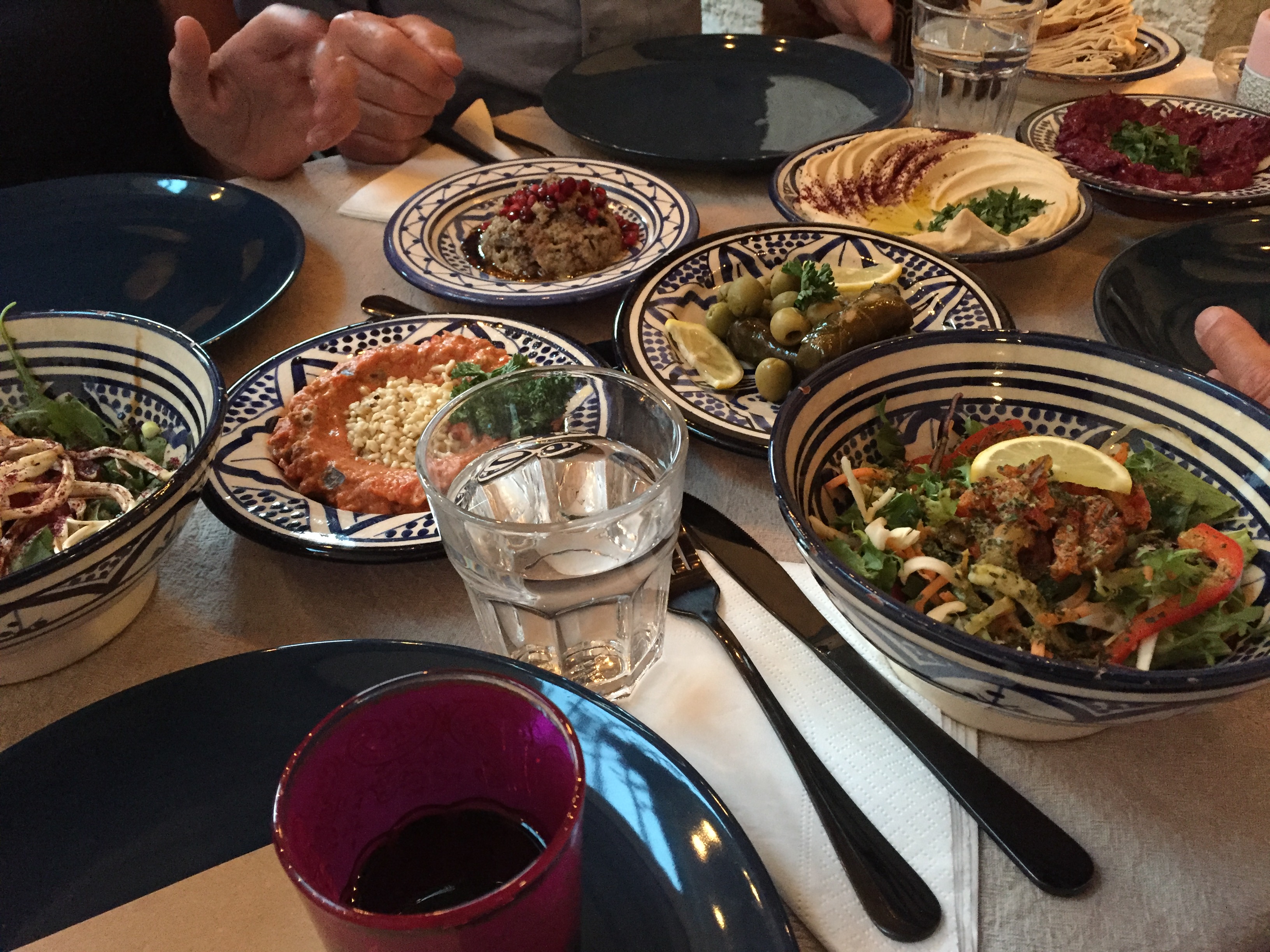 Syrian starters of many colours laid out in bowls on a table