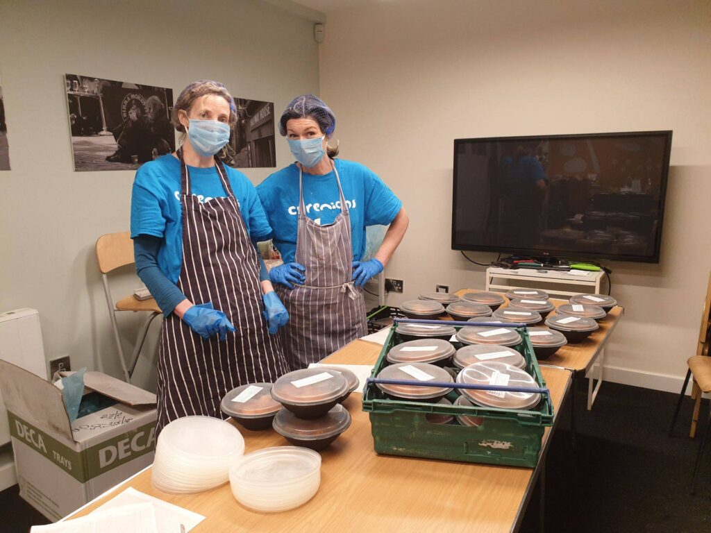 Cyrenians kitchen volunteers in masks and gloves preparing food for delivery