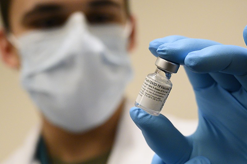 Army Spc. Angel Laureano holds a vial of the COVID-19 vaccine, Walter Reed National Military Medical Center, Bethesda, Md., Dec. 14, 2020. (DoD photo by Lisa Ferdinando) CC BY 2.0