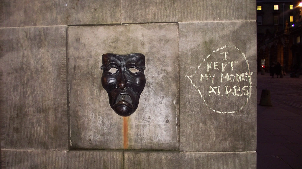 The sad face of the drama mask – with graffiti 'I put my money in RBS'