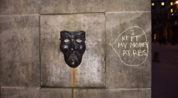 The sad face of the drama mask – with graffiti 'I put my money in RBS'
