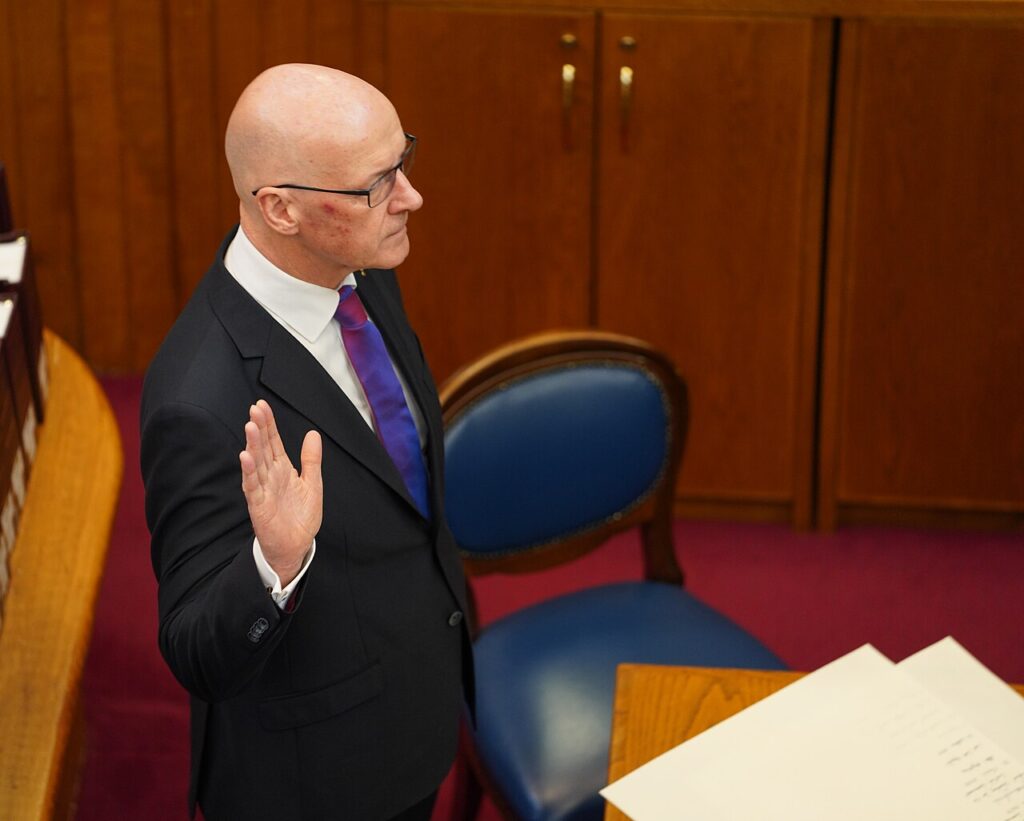 John Swinney being sworn in as 7th First Minister of the Scottish Parliament in 2024. Photo Scottish Government, CC BY 2.0