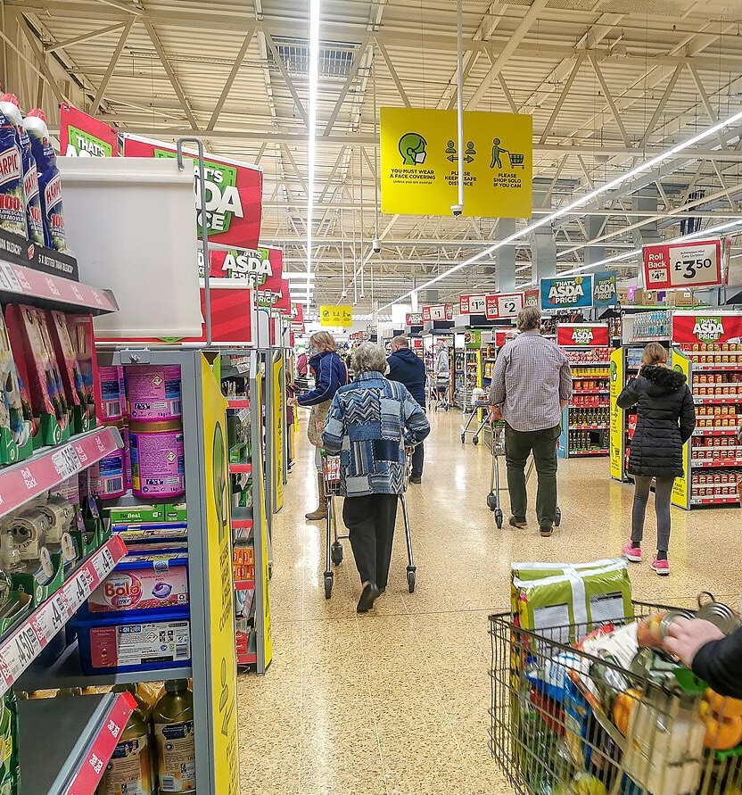 shoppers pushing baskets throughf ASDA